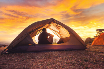 men camping in a tent on vacation in a national park ,Tent camping at sunrise and sunset
