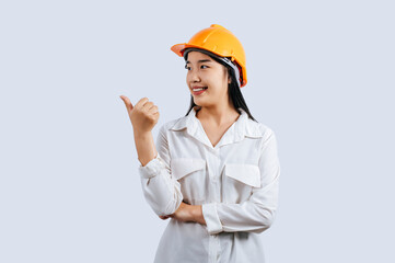 Young female engineer in helmet stand with thumb up posture