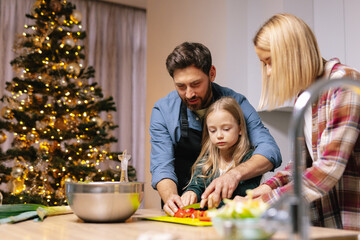 Family prepare food Dinner Christmas tree interior together