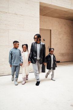Family in fall fashion holding hands walking  in shopping center