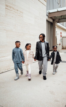 Family in fall fashion holding hands walking  in shopping center