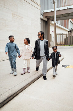 Family in fall fashion holding hands walking  in shopping center