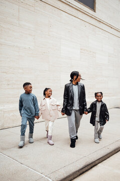 Family in fall fashion holding hands walking  in shopping center