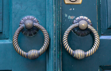 Antique Metal Door Knob. Classic brass door knob on green door vintage style. - Powered by Adobe