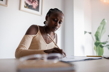 Black freelancer correcting architectural scheme