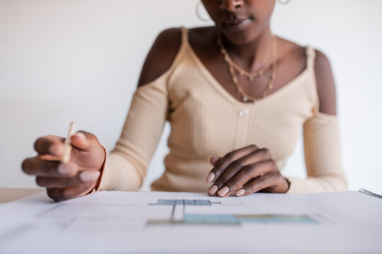 African American woman checking architectural draft