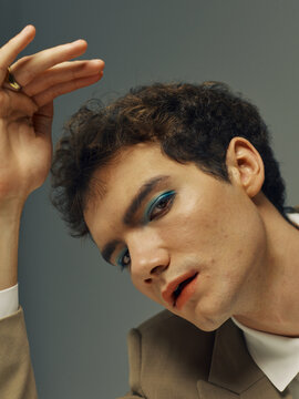 Man wearing blue eyeshadow
