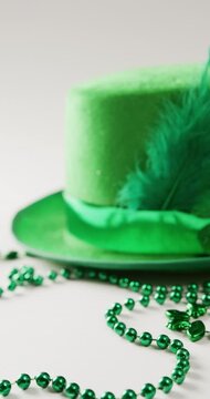 Vertical video of of st patrick's green hat and necklace with copy space on white background