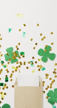 Vertical video of of st patrick's green shamrock and letter with copy space on white background