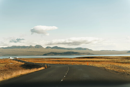 Empty Road Into The Horizon. Mountains And Open Sky On Background