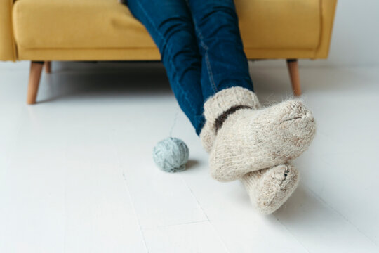 Feet in warm knitted socks.