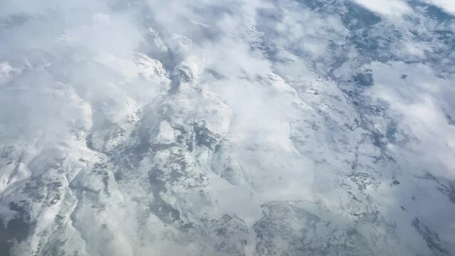Aerial Above Clouds and Snowy Mountains