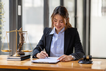 Business Asian woman in suit and Lawyer working on a documents at workplace office. Judge gavel with Justice lawyers,  Legal law, advice  and justice concept