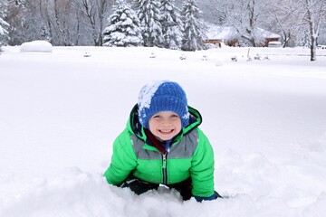 small child playing in snow