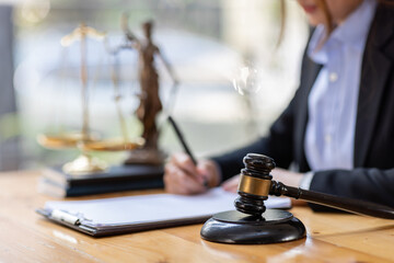 Business Asian woman in suit and Lawyer working on a documents at workplace office. Judge gavel with Justice lawyers,  Legal law, advice  and justice concept