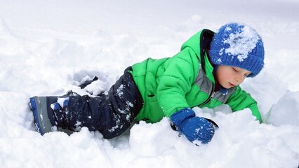little child playing with snow