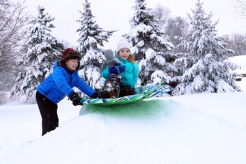 children with doll on sled