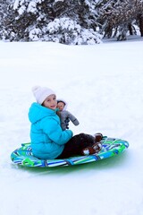 Fototapeta na wymiar child with doll on sled