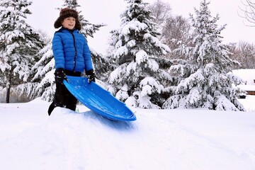 child with a sled