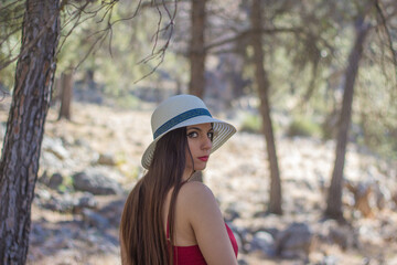 A young woman in a relaxing way in a forest during a sunny spring day