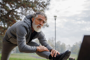 Senior active man stretching leg