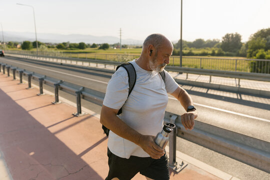 Man Checking The Time On His Smartwatch