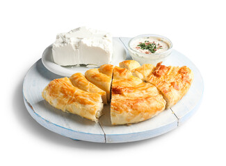 Board with pieces of delicious cheese pie, sour cream and feta isolated on white background