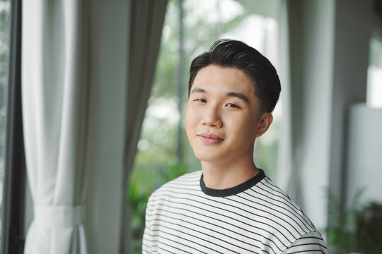 Headshot Portrait Of Smiling Asian Young Male Employee Look At Camera