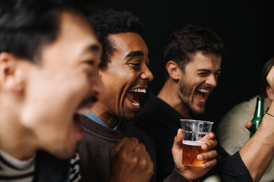 Men Watching Game and Cheering