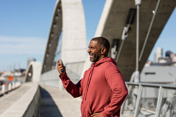 Asthmatic Man Takes A Break From Exercise To Use Inhaler 