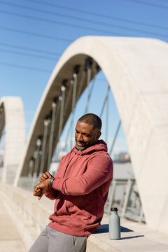 Fit Man Takes A Break From Exercise To Check His Smart Watch