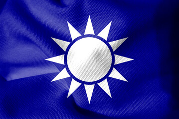 Fabric flag of Kuomintang. A white Sun with twelve rays on blue background.