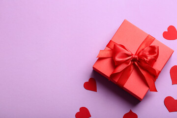 Beautiful gift and paper hearts on pink background. Valentine's Day celebration