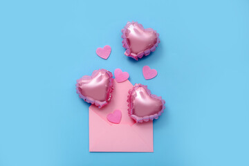 Composition with balloons, envelope and decor on color background. Valentine's Day celebration
