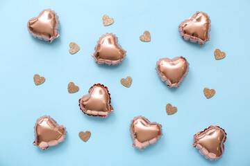 Composition with heart shaped foil balloons and decor on color background. Valentine's Day celebration