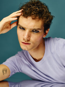 Man with black eyeliner studio portrait