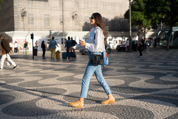Beautiful woman walking in the street candid portrait