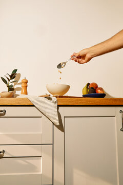 Pouring beans into a bowl to cook them