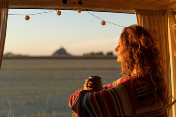 woman with coffe in camper van