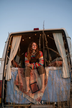 Woman sitting in camper van