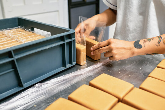 Hands packaging dulce de leche blocks