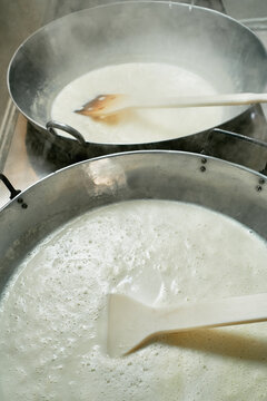 Pots cooking milk