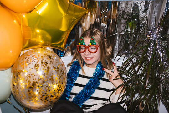 The girl shows her fingers the sign "v" Victoria, New Year's party.