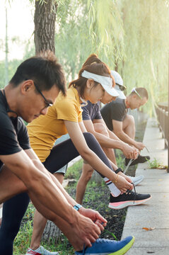 Groups of friends tying shoelaces
