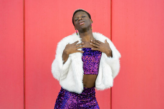 Transgender woman with sequined suit and white coat