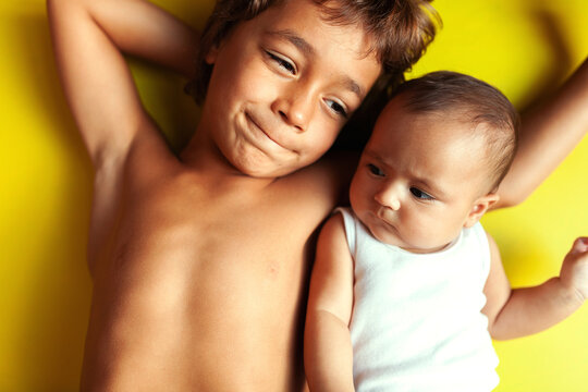 siblings on yellow background