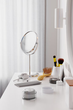 Hand cream, cosmetics, phone on dressing table. Interior shot.