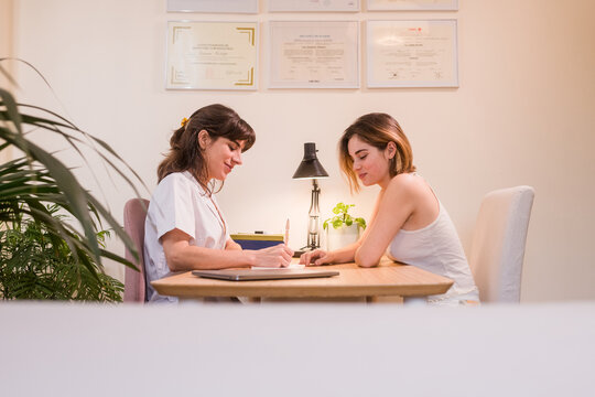 Female doctor explaining treatment to young patient