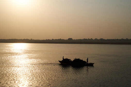 Boats with wood for funeral pyres being delivered to burning ghats