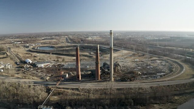 Drone shot of demolished coal power plant with smoke stacks